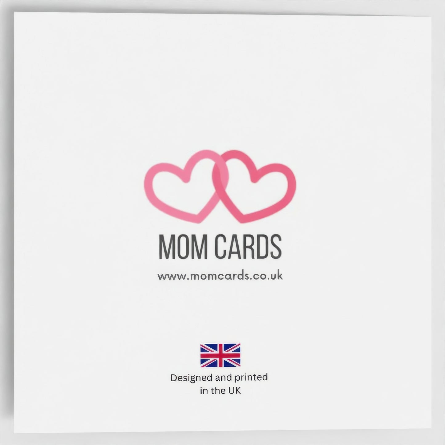The reverse of the card which has Mom Cards logo of two entwined pink hearts, and 'Designed and printed in the UK' stamp.