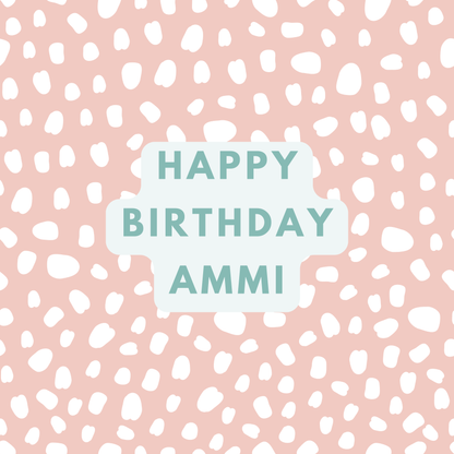 The card design. Text reads: "Happy Birthday Ammi" in green text. Pink background with white paint dabs.