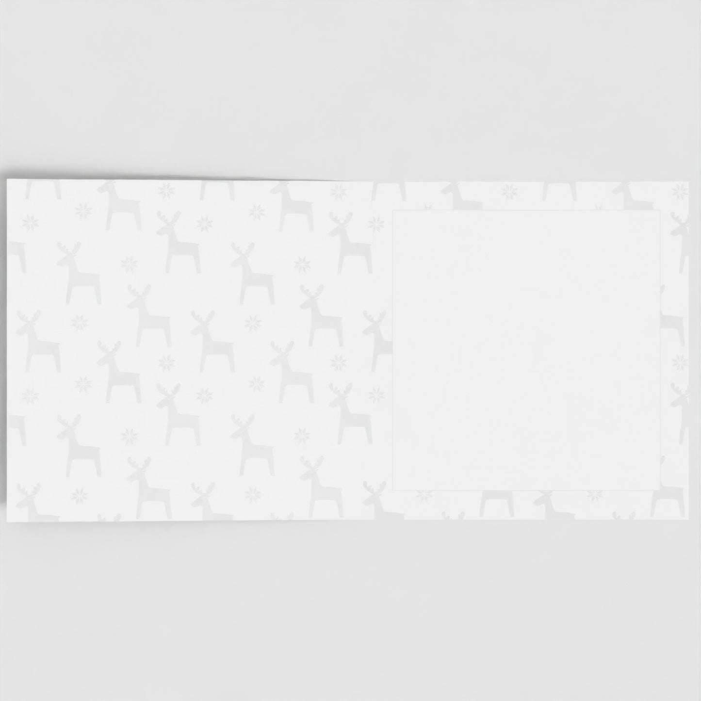 The inside of the card. Pastel grey reindeer pattern, with a blank white square to write your own message in.