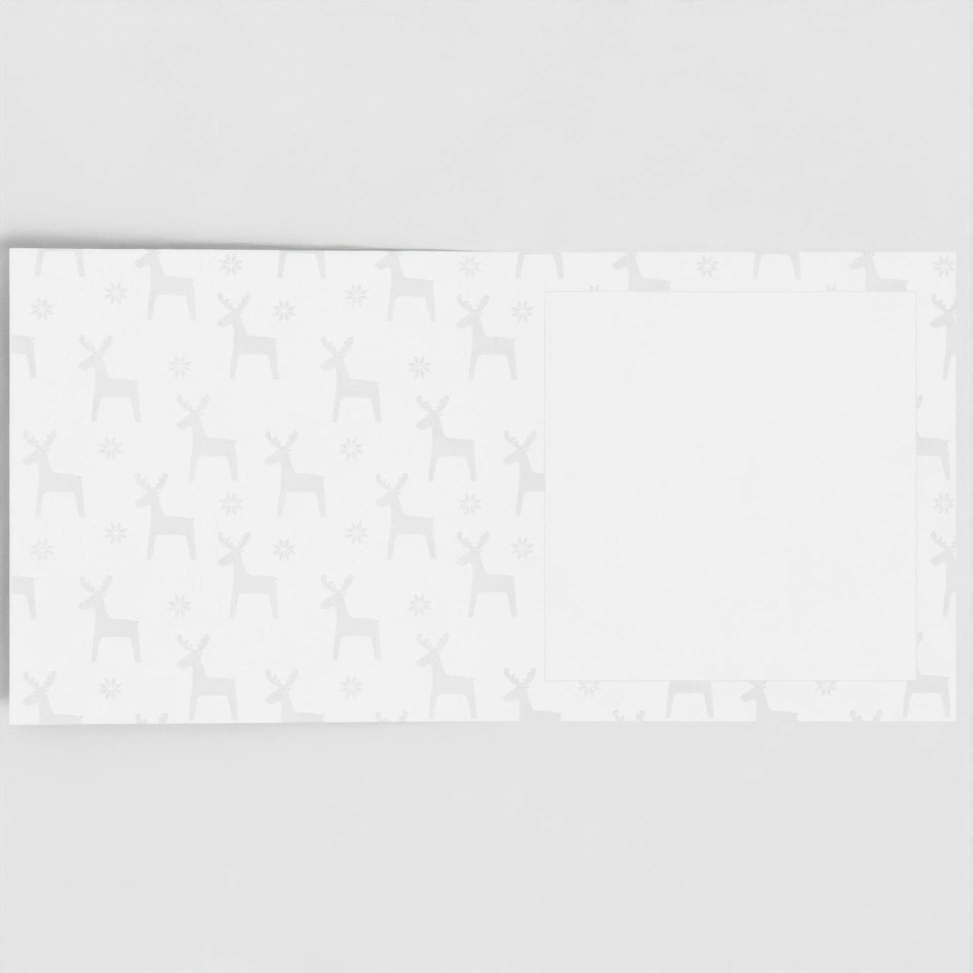 The inside of the card. Pastel grey reindeer pattern, with a blank white square to write your own message in.