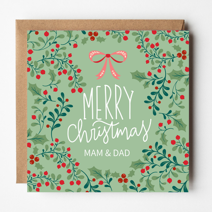 A mockup of the Holly Berries Christmas card for Mam & Dad, shown with brown Kraft envelope.