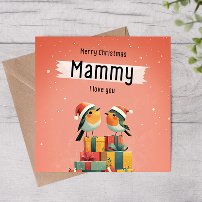 The design: two little xmas robins perched atop a pile of presents. Text reads: Merry Christmas Mammy, I love you.