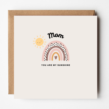 Card design: rainbow and smiling sunshine in muted pastels. Text reads: "Mom, you are my sunshine."
