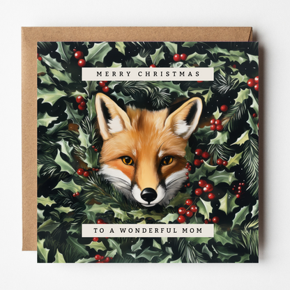 The design: lifelike painting of a red fox peering out through winter foliage. Text reads: Merry Christmas to a wonderful Mom.