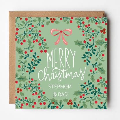 A mockup of the Holly Berries Christmas card for Stepmom & Dad, shown with brown Kraft envelope.